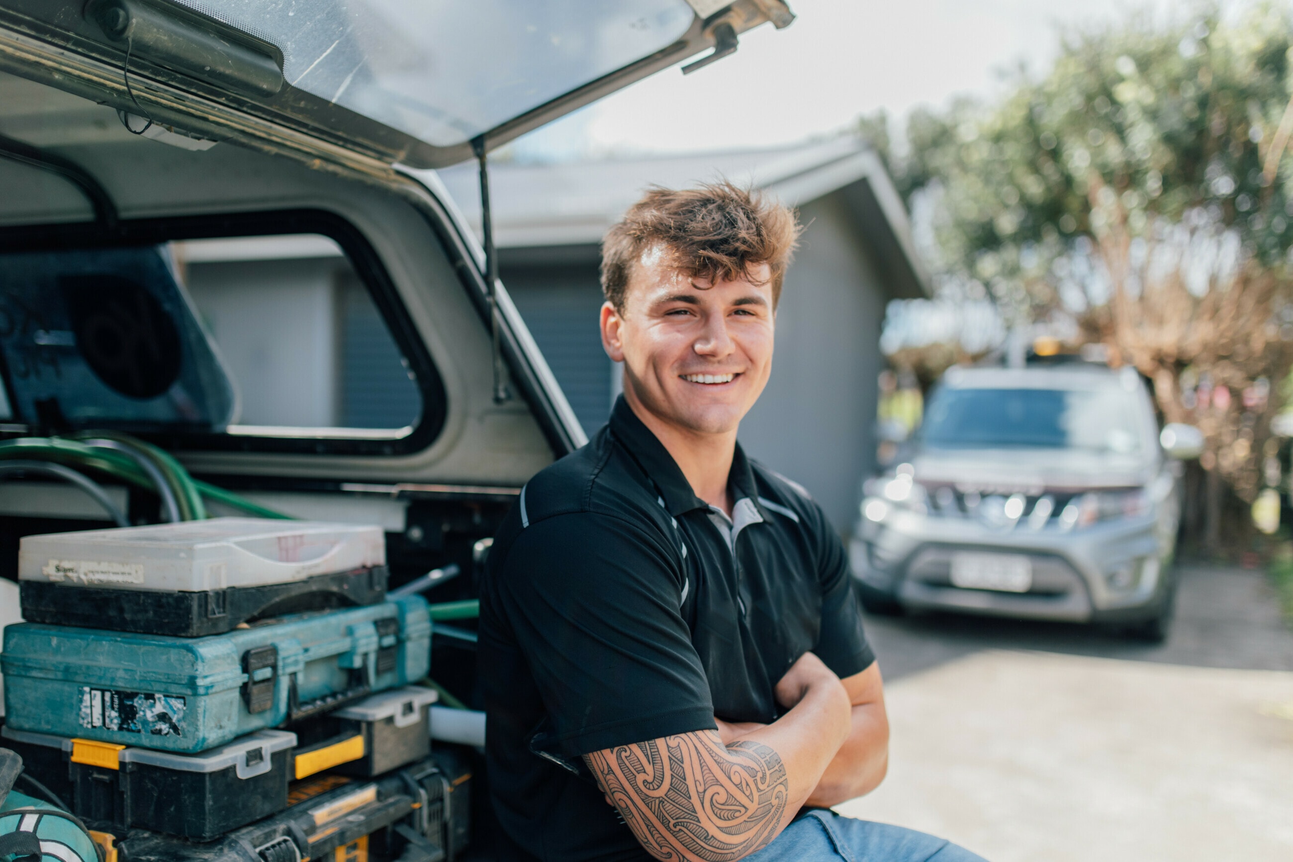 A tradie at the tailgate of his ute